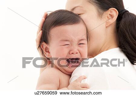 Stock Photo - Mother Holding Crying Baby. Fotosearch