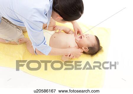 Stock Photo - Mother Tickling Baby Boy. Fotosearch