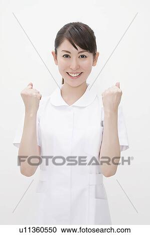 Stock Image - Nurse punching the air. Fotosearch
