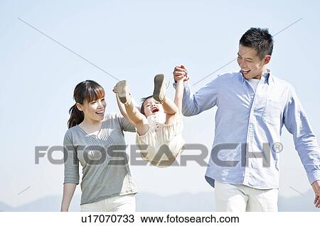 Parents swinging daughter View Large Photo Image Stock Image - Parents swinging daughter. Fotosearch