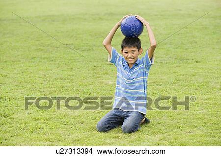 Picture - Portrait of a boy with soccer ball, Chiba Prefecture, Honshu, Japan. Fotosearch