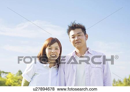 Stock Photo - Portrait of young couple smiling. Fotosearch