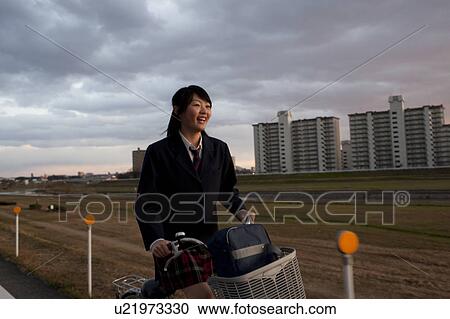 Stock Image - Schoolgirl Cycling. Fotosearch