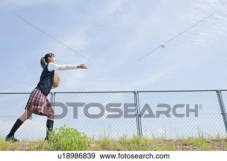 Stock Photo - Schoolgirl Playing Baseball. Fotosearch