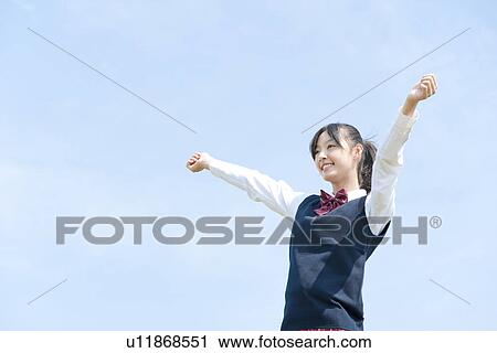 Stock Image - Schoolgirl with Arms Outstretched. Fotosearch