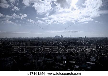 Stock Photograph - Sun Breaking Through Clouds Over Tokyo. Fotosearch