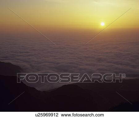 Stock Image - Sun Rising Over Sea. Fotosearch