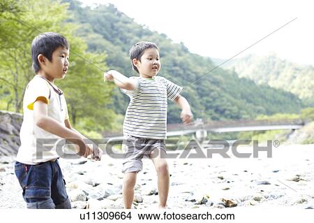 Picture - Two Boys Playing in Water. Fotosearch