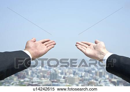 Two businessmen holding hands out View Large Photo Image Stock Photography - Two businessmen holding hands out. Fotosearch