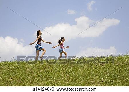 Two Girls Marching in Field View Large Photo Image Stock Photo - Two Girls Marching in Field. Fotosearch