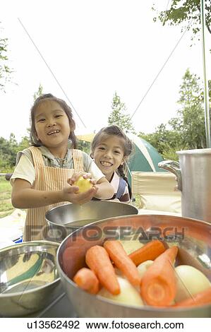 Two Girls Washing Vegetables at Campsite View Large Photo Image Stock Image - Two Girls Washing Vegetables at Campsite. Fotosearch