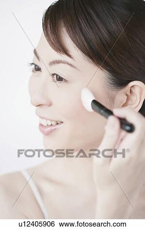 Woman applying make up View Large Photo Image Stock Photograph - Woman applying make up. Fotosearch
