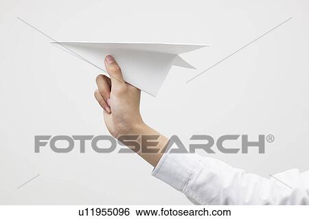 Stock Photograph - Woman holding a paper plane. Fotosearch