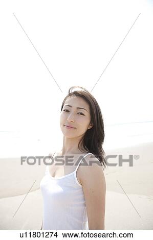 Picture - Woman looking at camera at beach, Ibaraki Prefecture, Honshu, Japan. Fotosearch