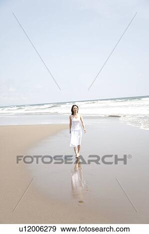 Stock Photo - Woman looking at camera at beach, Ibaraki Prefecture, Honshu, Japan. Fotosearch