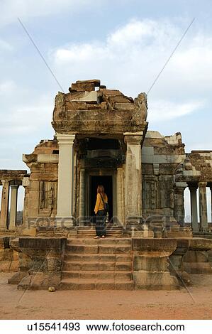 Stock Image - Woman Looking at Old Ruin. Fotosearch