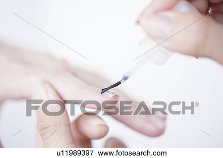 Stock Photo - Woman receiving a manicure. Fotosearch