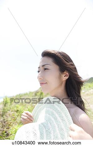 Woman standing at beach holding straw hat, Ibaraki Prefecture, Honshu, Japan View Large Photo Image Stock Image - Woman standing at beach holding straw hat, Ibaraki Prefecture, Honshu, Japan. Fotosearch