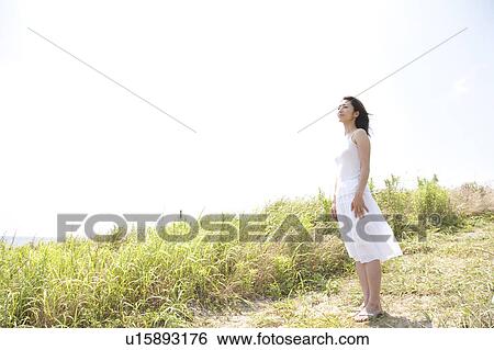 Woman standing at beach, Ibaraki Prefecture, Honshu, Japan View Large Photo Image Stock Photograph - Woman standing at beach, Ibaraki Prefecture, Honshu, Japan. Fotosearch