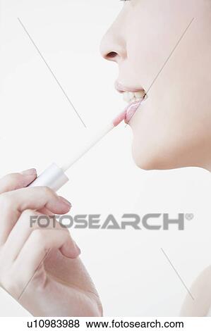 Woman wearing a lip gloss View Large Photo Image Stock Photo - Woman wearing a lip gloss. Fotosearch