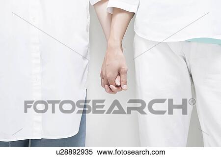 Stock Photography - Young couple holding hands. Fotosearch