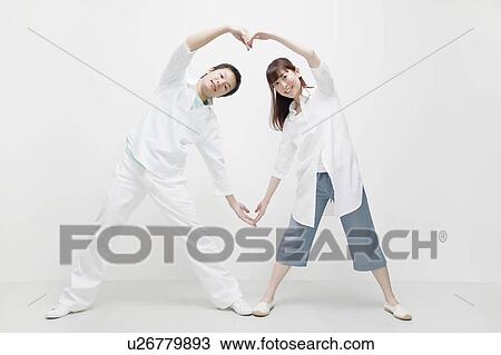 Young couple making a heart shape View Large Photo Image Stock Image - Young couple making a heart shape. Fotosearch