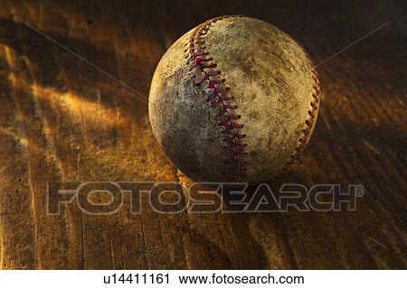 Stock Image - Antique baseball on wooden floor. Fotosearch