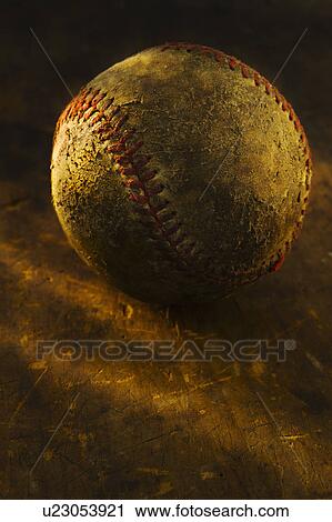 Stock Image - Antique baseball on wooden floor. Fotosearch