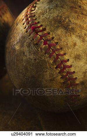 Stock Image - Antique baseball on wooden floor. Fotosearch