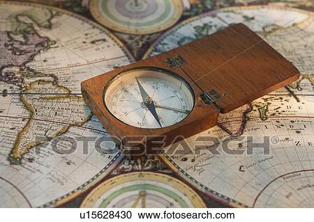 Stock Image - Antique compass on map. Fotosearch