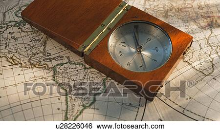 Stock Photograph - Antique compass on map. Fotosearch