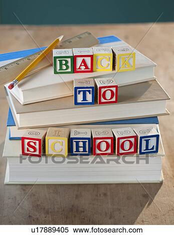 Stock Photography - Back to school building blocks on stacked books pencil and ruler. Fotosearch