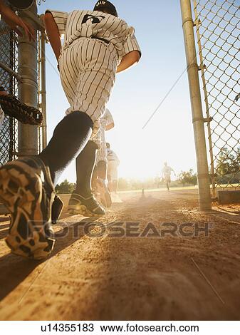 Baseball players (10-11) entering baseball diamond View Large Photo Image Stock Image - Baseball players (10-11) entering baseball diamond. Fotosearch
