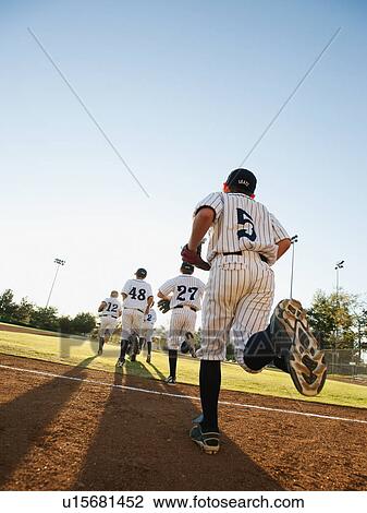 Baseball players (10-11) running on baseball diamond View Large Photo Image Stock Image - Baseball players (10-11) running on baseball diamond. Fotosearch