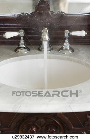 Bathroom sink with hot water running View Large Photo Image Stock Photo - Bathroom sink with hot water running. Fotosearch