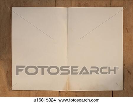 Picture - Blank page on wooden table. Fotosearch