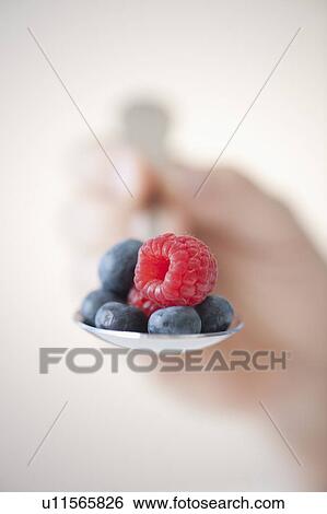 Blueberries and raspberry on spoon View Large Photo Image Stock Photograph - Blueberries and raspberry on spoon. Fotosearch