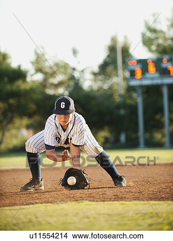 Picture - Boy (10-11) playing baseball. Fotosearch