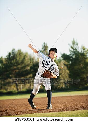 Boy (10-11) playing baseball View Large Photo Image Stock Image - Boy (10-11) playing baseball. Fotosearch
