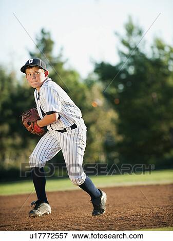 Boy (10-11) playing baseball View Large Photo Image Stock Photo - Boy (10-11) playing baseball. Fotosearch