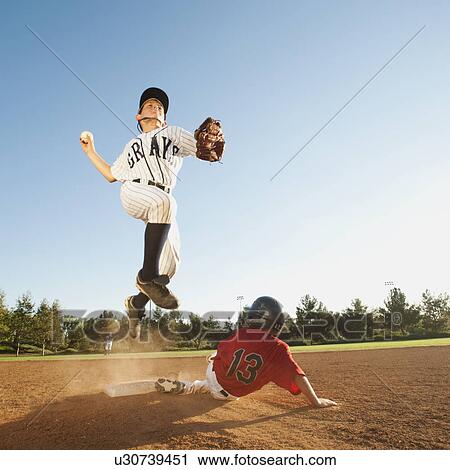 Boys (10-11) playing baseball View Large Photo Image Stock Image - Boys (10-11) playing baseball. Fotosearch