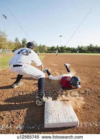 Stock Photography - Boys (10-11) playing baseball. Fotosearch