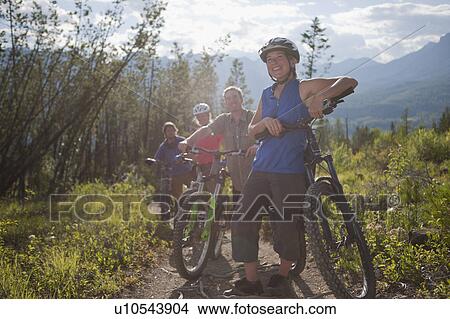 Canada, British Columbia, Fernie, Group of four friends enjoying mountain biking View Large Photo Image Picture - Canada, British Columbia, Fernie, Group of four friends enjoying mountain biking. Fotosearch