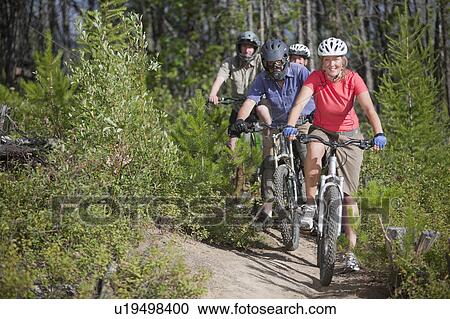 Stock Image - Canada, British Columbia, Fernie, Group of five people enjoying mountain biking. Fotosearch