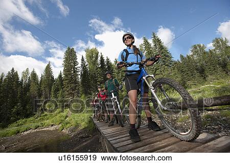 Stock Photo - Canada, British Columbia, Fernie, Group of five people enjoying mountain biking. Fotosearch