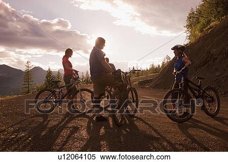 Canada, British Columbia, Fernie, group of four friends enjoying mountain biking View Large Photo Image Stock Photography - Canada, British Columbia, Fernie, group of four friends enjoying mountain biking. Fotosearch