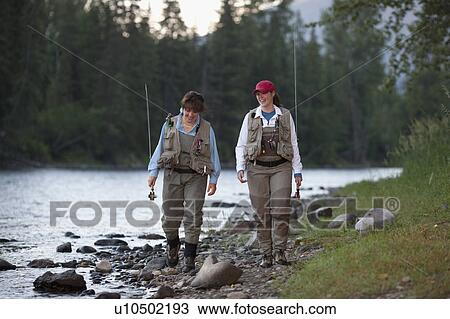 Stock Image - Canada, British Columbia, Fernie, daughter and mother fly fishing. Fotosearch