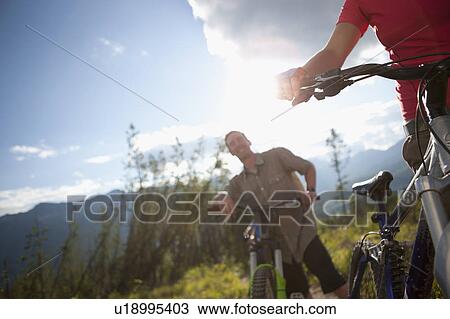Canada, British Columbia, Fernie, Friends enjoying mountain biking View Large Photo Image Stock Image - Canada, British Columbia, Fernie, Friends enjoying mountain biking. Fotosearch