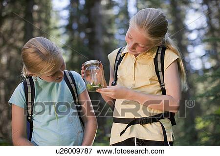 Canada, British Columbia, Fernie, two girls examining animal closed in jar View Large Photo Image Stock Photo - Canada, British Columbia, Fernie, two girls examining animal closed in jar. Fotosearch