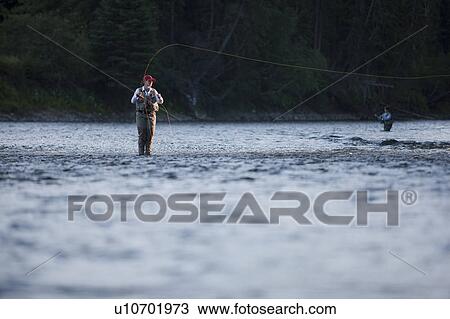 Canada, British Columbia, Fernie, Woman fly fishing in river View Large Photo Image Stock Image - Canada, British Columbia, Fernie, Woman fly fishing in river. Fotosearch